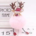Detail of Christmas reindeer plush keychain featuring a pink faux fur pompom and festive hat - Light Pink