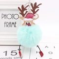 Close-up of reindeer plush ball keychain with blue fur, brown antlers and red Santa hat - Mint Green