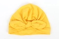 Detailed view of bright yellow baby turban hat with a large bow in soft knit fabric - Yellow