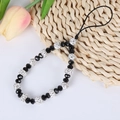 Macro detail of beaded phone strap with faceted black beads and rhinestone accents - A140 Black Beaded Bracelet