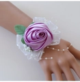 Detail of purple satin rose wrist corsage with lace and faux pearl accents for bridesmaids - Pink Purple