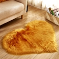 Golden heart-shaped faux fur rug with plush texture on a cozy wooden floor - Heart 50*70cm / Camel Yellow