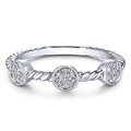 Macro shot of twisted silver ring featuring three circular pave-set zircon stones - US 6 / White