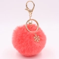 Plush snowflake keychain in vibrant pink faux fur with golden metal hook and snowflake charm - Orange Red