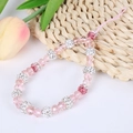 Pink acrylic bead phone strap with sparkling diamond accents on a rustic woven mat - A141 Pink Beaded Bracelet