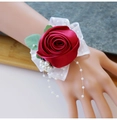 Close-up of deep red satin rose wrist corsage with lace straps and pearl beads - Burgundy