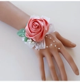 Detailed shot of pink satin rose wrist corsage with lace and pearls for bridesmaids - Watermelon red