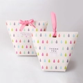 Close-up of colorful droplet gift boxes with elegant pink ribbons and thank you labels - Colorful Water Drops