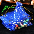 Blue organza gift bag with gold star moon patterns and drawstring closure - Royal Blue