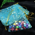 Blue organza gift bag 9x12cm with gold star moon patterns and colorful beads inside - Lake Blue