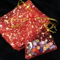 Red organza gift bag with gold stars and moon pattern filled with colorful beads - 9*12cm / Red