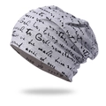 Close-up of light gray knit beanie featuring decorative black cursive letter patterns - One Size / Light Gray