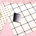 Macro shot of 12 glitter metal wave hairpins in black and silver on a pink background - Glitter Black