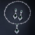 Detailed view of silver bridal jewelry set with emerald stones and zircon accents - Stud Pin Style / Green