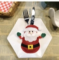 Detail of Santa Claus utensil holder on white plate with festive Christmas setting - Style B Santa Claus