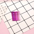 Close-up of glittery pink and purple gradient metal bobby pins on a display card - Glitter Rose Red