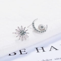 Elegant silver asymmetrical star and moon stud earrings with sparkling cubic zirconia - White Gold