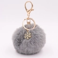 Detail of gray plush keychain with golden alloy snowflake pendant and lobster clasp - Medium Grey