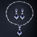 Macro shot of silver bridal jewelry set with blue teardrop and white marquise stones - Stud Pin Style / Blue
