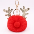 Detail of red plush Christmas reindeer keychain with golden sequin antlers and metal clasp - Red