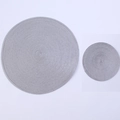 Detail of round grey woven place mats with concentric texture for kitchen and dining - Silver Gray