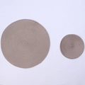Detail of round beige woven placemats in two sizes, heat-resistant and non-slip - Brown