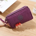 Portafoglio donna in nylon viola scuro con tre cerniere e cinturino da polso - Viola scuro