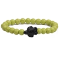 Detailed view of light green turquoise beads with a black turtle charm on elastic cord - Fruit Green Turquoise