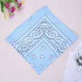Light blue paisley bandana with classic cashew pattern folded on a wooden surface - Sky Blue