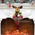 Christmas reindeer gift bag hanging on a cozy fireplace mantel with warm holiday decorations - Reindeer Style