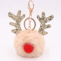 Detailed view of beige plush reindeer keychain with golden glitter antlers and red nose - Nude
