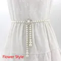 Elegant white pearl waist chain featuring a rhinestone flower buckle on white dress - Flower Style