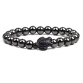 Handmade hematite beaded bracelet featuring a matte black turtle charm on white background - Hematite