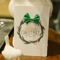 White Christmas card with green wreath and ribbon bow, featuring merry Christmas text - Green