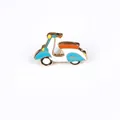 Cute vintage scooter enamel pin with blue and orange colors on golden metal base - Motorcycle