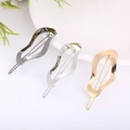 Minimalist metallic wave hair clips in dark gunmetal, bright silver, and gold finish - Wavy Gold