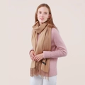 Thick warm camel cashmere scarf with fringe details worn as a cozy winter shawl - Camel