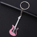 Pink and black electric guitar metal keychain with silver chain on black leather background - Large Pink Guitar