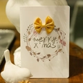 White Christmas greeting card with yellow satin bow and handwritten Merry X'mas wreath - Gold