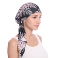 Detail shot of black turban hat with pink fern leaf print on soft milk silk fabric - Black + Pink