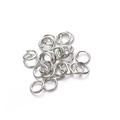 Macro view of silver metal jump rings and split rings for DIY jewelry making - White K (flat-cut Needs To Be Broken Open)