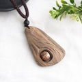 Ethnic style long sweater necklace featuring hand-carved wood pendant and brown woven rope - Style 16
