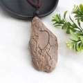Handmade ethnic sweater necklace featuring a dark brown wood pendant and woven cord - Style 7