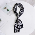 Grey and black leopard print narrow twilly silk scarf tied on minimalist magazine backdrop - Leopard Black White
