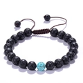 Detailed view of porous black lava stone bracelet with blue turquoise bead on white background - Black Lava Stone with Single Blue Turquoise (No. 5)