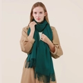 Dark green wool blend scarf with fringe tassels shown on a model in a camel coat - Dark Green