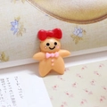 Handmade gingerbread man resin charm with red bow on vintage floral background paper - Girls
