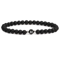 Macro detail of black matte stone bracelet with letter H bead and silver spacers - Letter H