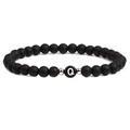 Detail of matte black beaded bracelet featuring white letter Q charm and silver accents - Letter Q