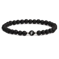 Detailed macro view of 6mm matte black stones and silver metal beads with letter F charm - Letter F